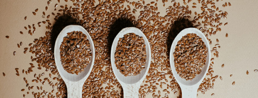 Three spoons full of flaxseed, an ingredient often included in horse diets